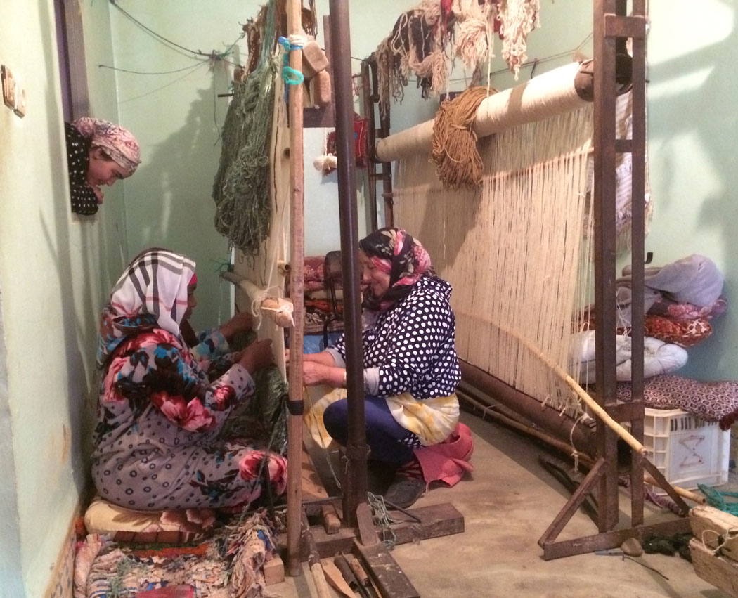 Women weaving carpets in M'Rirt